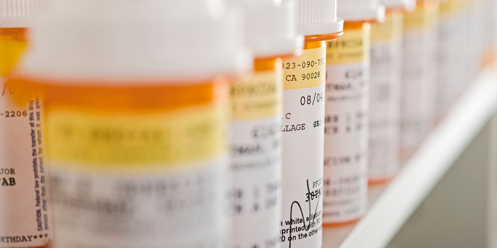 row of perscription medicine bottles with labels