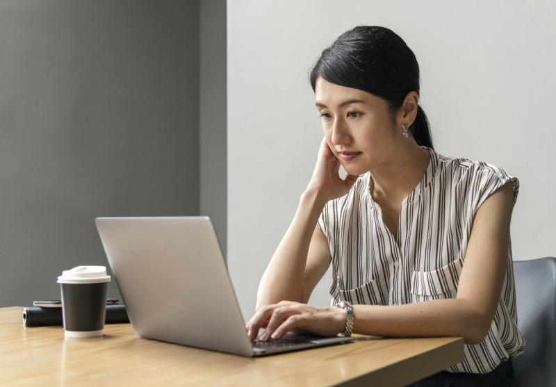 woman seated at desk working on a computer