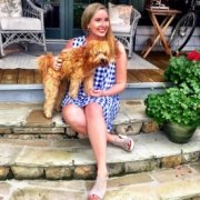 Katherine Craven, Fundraising Walker and Lupus Warrior, sits on the step with a service-dog-in-training