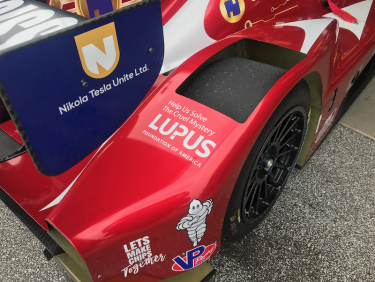 Red race car showing the Lupus Foundation of America branding.